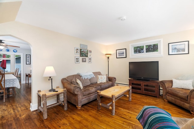 324 W Wabasha St, Duluth, MN 55803 - living area with wood finished floors, baseboard heating, a ceiling fan, and arched walkways