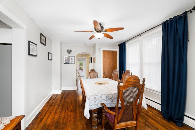 324 W Wabasha St, Duluth, MN 55803 - dining space with arched walkways, a baseboard heating unit, dark wood-type flooring, and a ceiling fan