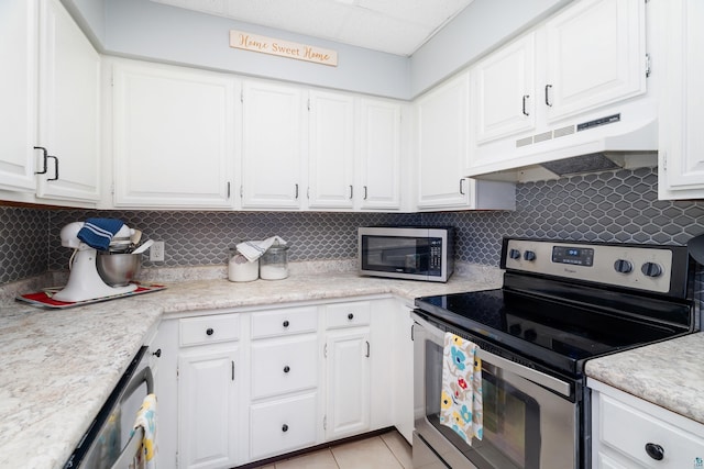 324 W Wabasha St, Duluth, MN 55803 - kitchen featuring stainless steel appliances, under cabinet range hood, light countertops, and white cabinets