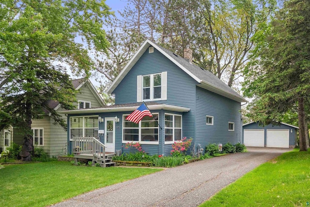 324 W Wabasha St, Duluth, MN 55803 - view of front of house featuring an outbuilding, a garage, a chimney, a front lawn, and a shingled roof