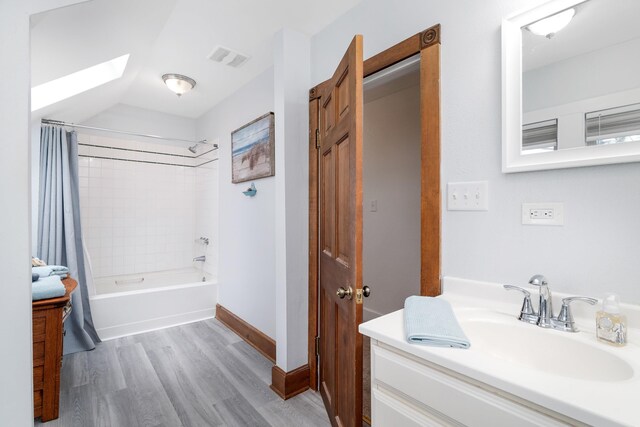 324 W Wabasha St, Duluth, MN 55803 - bathroom featuring a skylight, shower / tub combo, vanity, and wood finished floors
