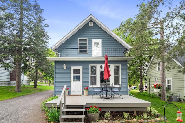 324 W Wabasha St, Duluth, MN 55803 - back of house with a wooden deck, a lawn, and a balcony