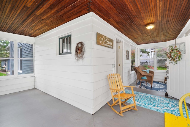 324 W Wabasha St, Duluth, MN 55803 - sunroom / solarium with wood ceiling, wood walls, and concrete floors