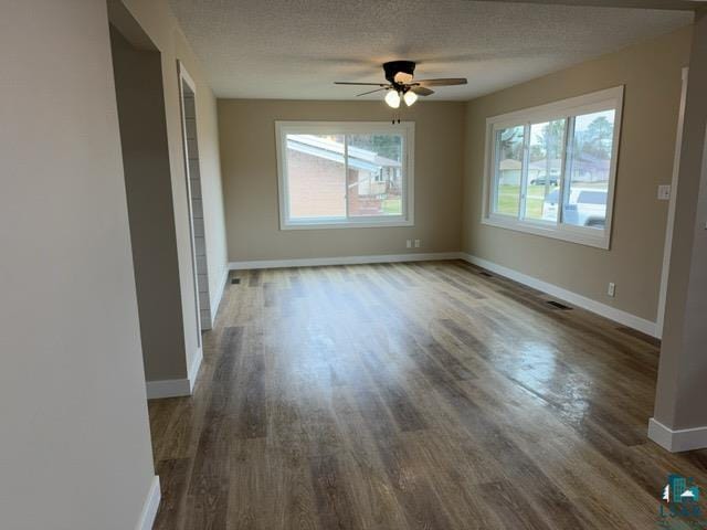 20 S Erie St, Aurora, MN 55705 - empty room with dark wood finished floors, a ceiling fan, and a textured ceiling