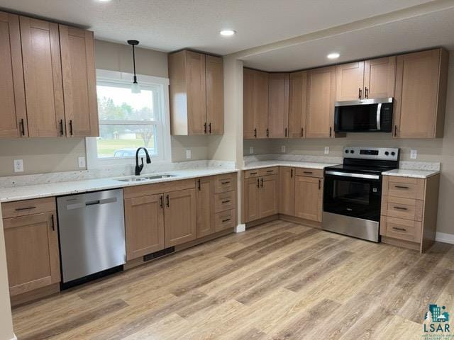 20 S Erie St, Aurora, MN 55705 - kitchen featuring appliances with stainless steel finishes, light wood-style flooring, recessed lighting, and decorative light fixtures