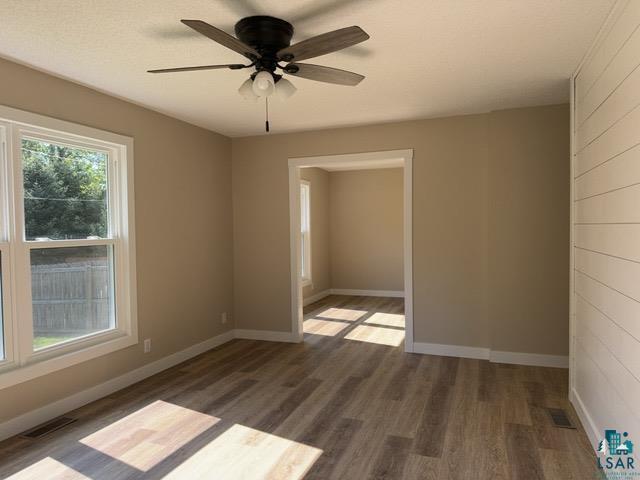 20 S Erie St, Aurora, MN 55705 - spare room with wood finished floors and ceiling fan