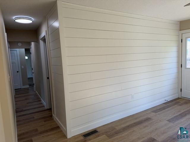 20 S Erie St, Aurora, MN 55705 - corridor featuring wood finished floors