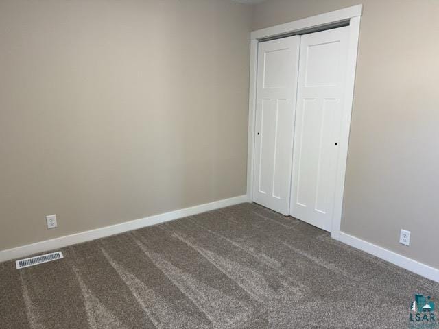 20 S Erie St, Aurora, MN 55705 - unfurnished bedroom with dark carpet and a closet
