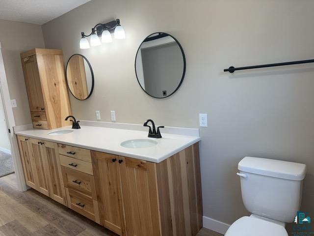 20 S Erie St, Aurora, MN 55705 - bathroom with double vanity and wood finished floors