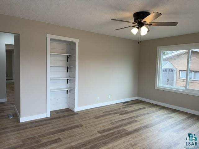 20 S Erie St, Aurora, MN 55705 - unfurnished bedroom with wood finished floors, a closet, and a ceiling fan