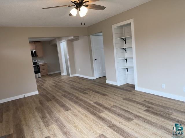 20 S Erie St, Aurora, MN 55705 - unfurnished living room with a ceiling fan and wood finished floors