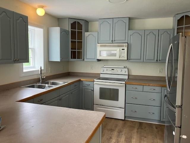 34358 State Highway 18, Finlayson, MN 55735 - kitchen featuring white appliances, gray cabinetry, dark wood-style floors, and glass insert cabinets