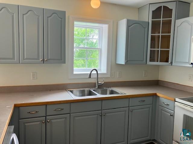 34358 State Highway 18, Finlayson, MN 55735 - kitchen with gray cabinets, white electric stove, glass insert cabinets, and light countertops