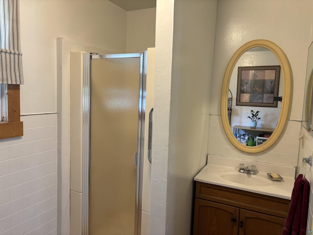 403 E Camp St, Ely, MN 55731 - bathroom with vanity, a stall shower, and tile walls