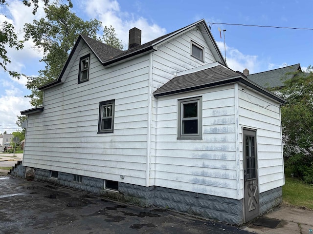 403 E Camp St, Ely, MN 55731 - view of side of property featuring a chimney and roof with shingles