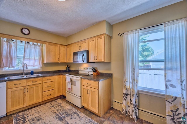 305 W Central Ave, Aurora, MN 55705 - kitchen featuring white appliances, a baseboard heating unit, plenty of natural light, a textured ceiling, and dark countertops