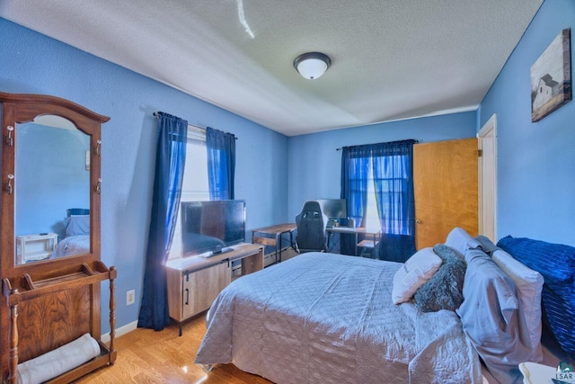 305 W Central Ave, Aurora, MN 55705 - bedroom featuring light wood-style floors and a textured ceiling