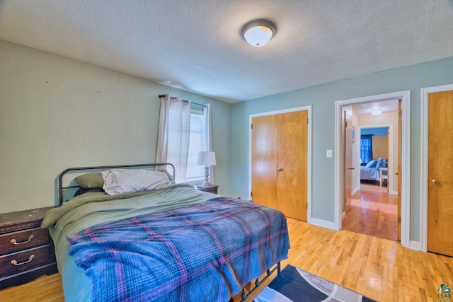 305 W Central Ave, Aurora, MN 55705 - bedroom featuring wood finished floors and a textured ceiling