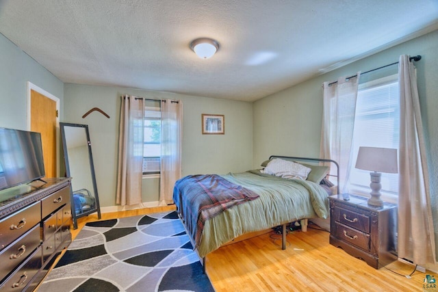 305 W Central Ave, Aurora, MN 55705 - bedroom with wood finished floors and a textured ceiling