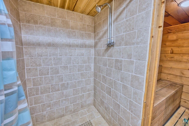 305 W Central Ave, Aurora, MN 55705 - full bathroom featuring wooden ceiling, a tile shower, and wood walls