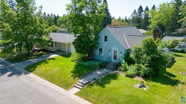 305 W Central Ave, Aurora, MN 55705 - view of front of house with a front lawn and a chimney