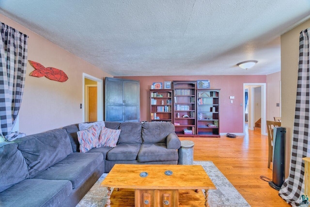 305 W Central Ave, Aurora, MN 55705 - living room with light wood-style floors and a textured ceiling
