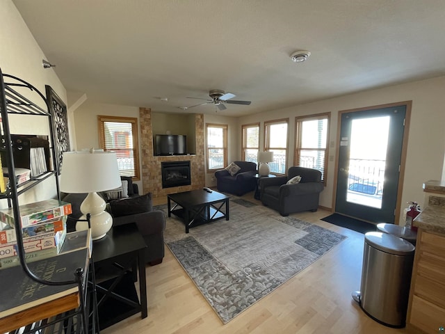 34 N 2nd St Unit 2, Bayfield, WI 54814 - living room featuring a large fireplace, a ceiling fan, and light wood-type flooring