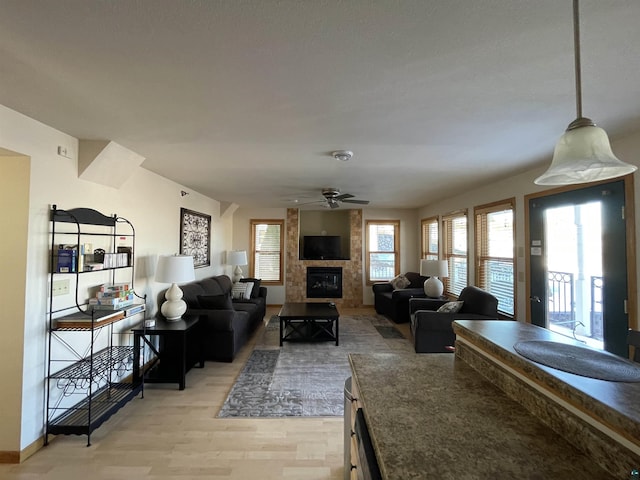 34 N 2nd St Unit 2, Bayfield, WI 54814 - living area with a tile fireplace, a ceiling fan, and light wood-type flooring