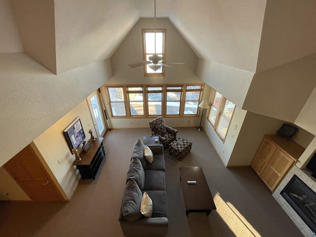 36 N 2nd St Unit 6, Bayfield, WI 54814 - living area with carpet, high vaulted ceiling, ceiling fan, and a glass covered fireplace