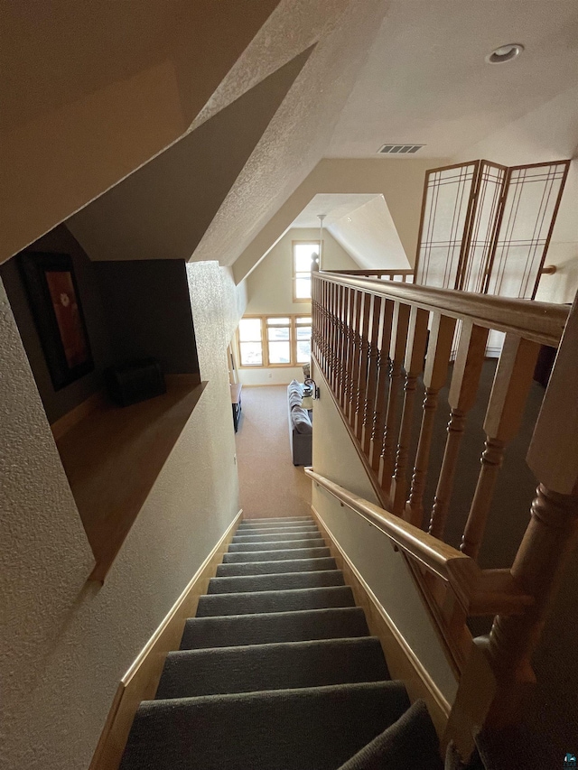 36 N 2nd St Unit 6, Bayfield, WI 54814 - stairway with carpet flooring, vaulted ceiling, recessed lighting, and a textured wall