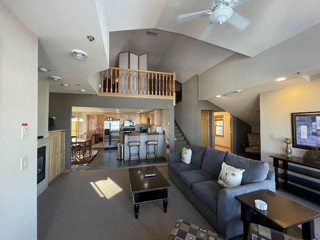 36 N 2nd St Unit 6, Bayfield, WI 54814 - living area featuring ceiling fan, vaulted ceiling, stairs, and a glass covered fireplace