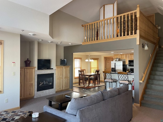 36 N 2nd St Unit 6, Bayfield, WI 54814 - living room featuring stairs, a fireplace, carpet flooring, and high vaulted ceiling
