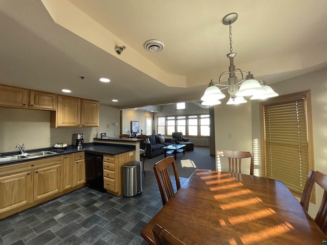 36 N 2nd St Unit 6, Bayfield, WI 54814 - kitchen with black dishwasher, a chandelier, light brown cabinetry, dark countertops, and a peninsula