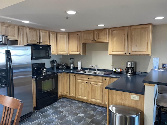 36 N 2nd St Unit 6, Bayfield, WI 54814 - kitchen featuring black appliances, dark countertops, a peninsula, light brown cabinetry, and recessed lighting