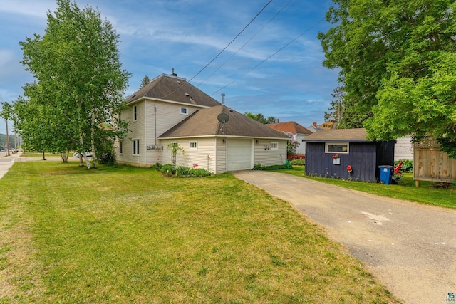 343 E Harvey St, Ely, MN 55731 - view of property exterior with asphalt driveway, a lawn, and an attached garage