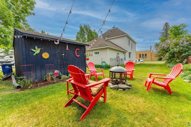 343 E Harvey St, Ely, MN 55731 - view of green lawn with a fire pit and an outdoor structure
