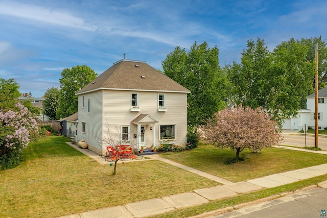 343 E Harvey St, Ely, MN 55731 - view of front of house featuring a front lawn and roof with shingles