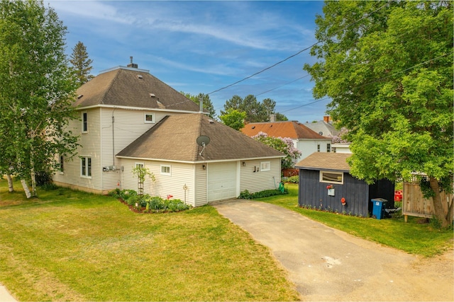 343 E Harvey St, Ely, MN 55731 - view of property exterior with asphalt driveway, an attached garage, a yard, and roof with shingles