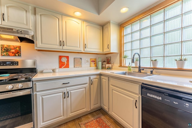 343 E Harvey St, Ely, MN 55731 - kitchen with black dishwasher, stainless steel range oven, under cabinet range hood, recessed lighting, and light wood finished floors