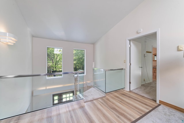 4921 W Pioneer Rd, Duluth, MN 55803 - empty room featuring a smoke detector, vaulted ceiling, and wood finished floors