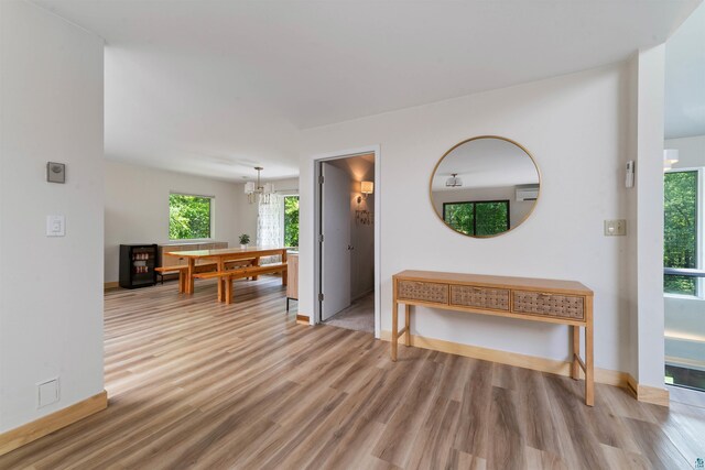 4921 W Pioneer Rd, Duluth, MN 55803 - hallway featuring light wood-style floors and a chandelier