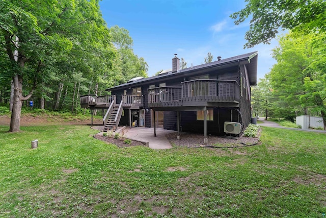 4921 W Pioneer Rd, Duluth, MN 55803 - back of property featuring a wooden deck, stairs, a yard, and a chimney