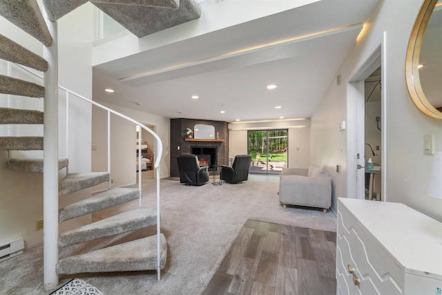 4921 W Pioneer Rd, Duluth, MN 55803 - living area featuring wood finished floors, stairs, a brick fireplace, recessed lighting, and baseboard heating