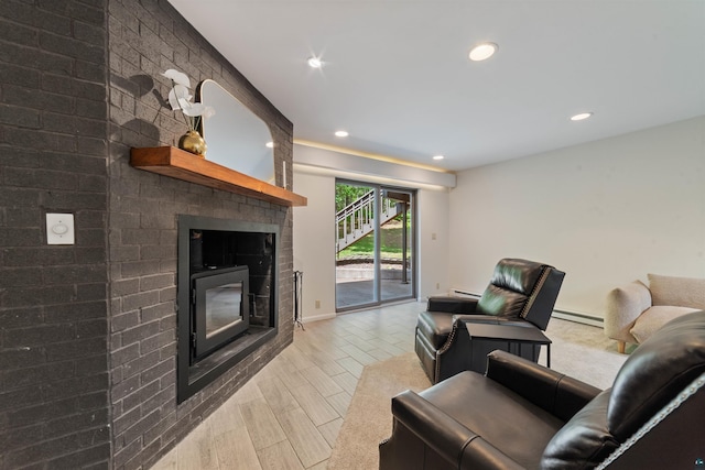 4921 W Pioneer Rd, Duluth, MN 55803 - living room with a fireplace, a baseboard radiator, recessed lighting, and a baseboard heating unit