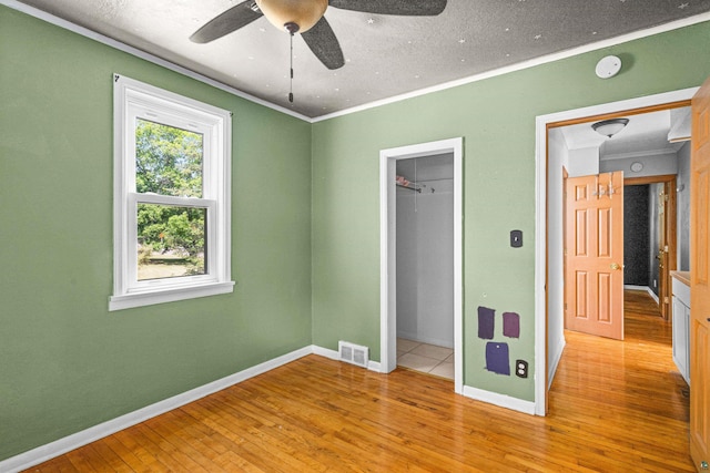 1707 Swan Lake Rd, Duluth, MN 55811 - unfurnished bedroom with ornamental molding, hardwood / wood-style flooring, a closet, and a ceiling fan