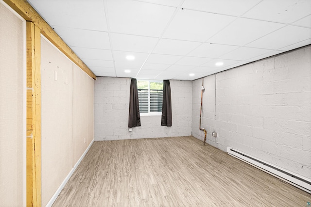 1707 Swan Lake Rd, Duluth, MN 55811 - below grade area with a baseboard heating unit, wood finished floors, a drop ceiling, and concrete block wall