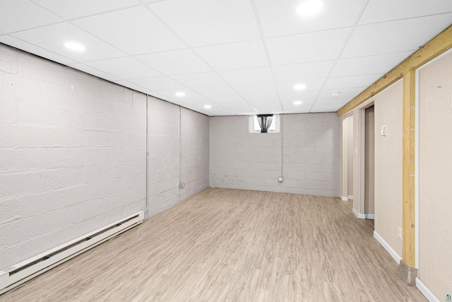 1707 Swan Lake Rd, Duluth, MN 55811 - basement featuring baseboard heating, wood finished floors, concrete block wall, and a drop ceiling