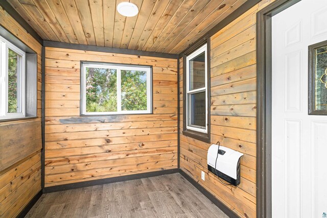 1707 Swan Lake Rd, Duluth, MN 55811 - unfurnished room with wooden walls, heating unit, healthy amount of natural light, wood ceiling, and wood finished floors