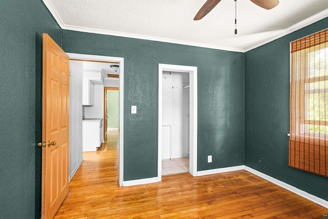 1707 Swan Lake Rd, Duluth, MN 55811 - unfurnished bedroom with ornamental molding, a textured wall, and light wood-style flooring