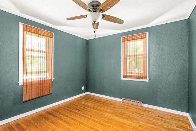 1707 Swan Lake Rd, Duluth, MN 55811 - empty room featuring hardwood / wood-style floors, ornamental molding, ceiling fan, and a textured wall